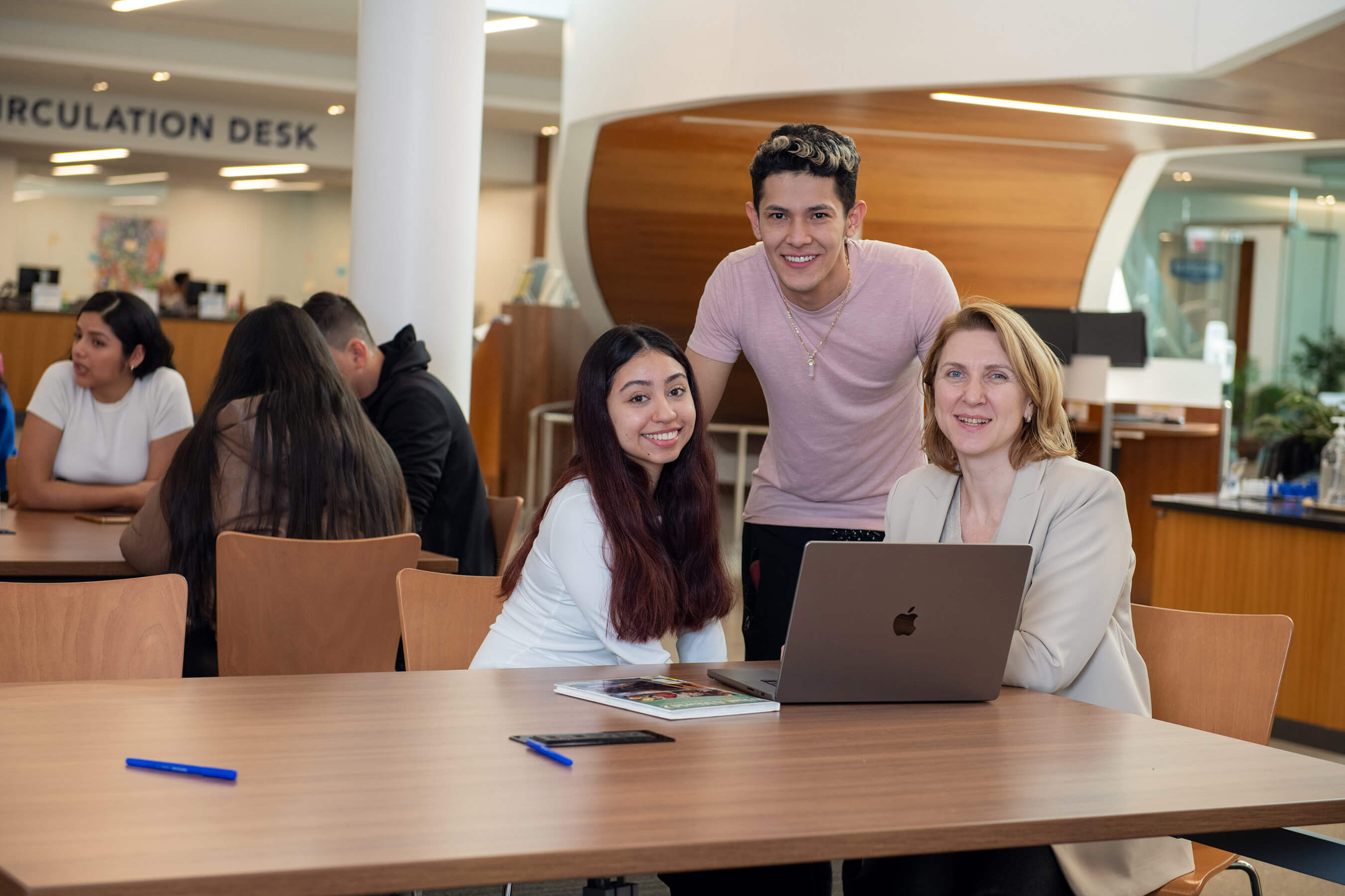 Image of two students meeting with an advisor at the Learning Resource Center at SUNY Suffolk's Michael J. Grant Campus.