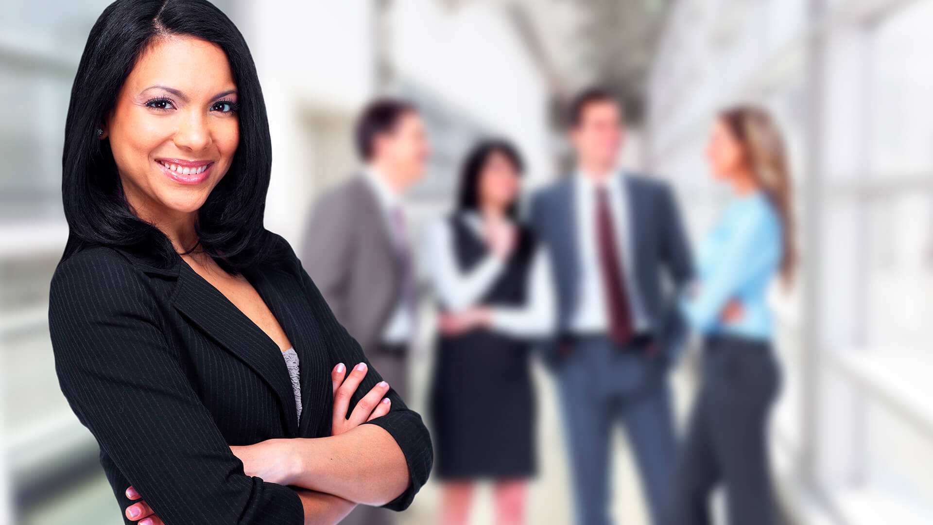 Business woman standing with folded arms.