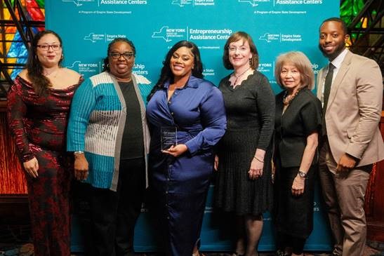 Photo Caption: (Left to right): Jennifer Kenney, Suffolk County Community College EAC Project Coordinator; Daphne M. Gordon, Ph.D., Suffolk County Community College Project Administrator; Joanne Laloi, Suffolk County Community College’s EAC client and the 2024 NYS Entrepreneur of the Year; Elizabeth Lusskin, Executive Vice President, Empire State Development Small Business & Technology Development; Bette Yee, Senior Director, Entrepreneur Development, Empire State Development; Earl Thomason Jr., Vice President of Entrepreneur Development, Empire State Development.  For a hi-res image, visit: https://photos.app.goo.gl/esofGQJdZFZ2r8P46